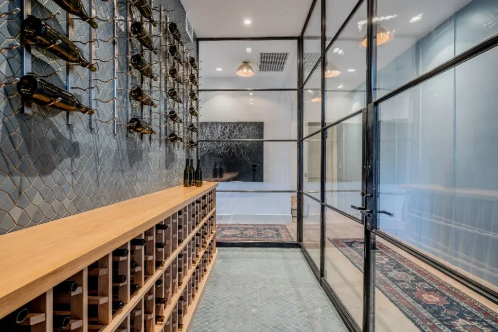 Custom bronze-framed glass enclosure for a wine room with modern industrial styling